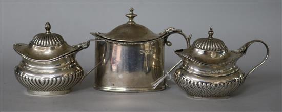 Three assorted silver mustard pots.